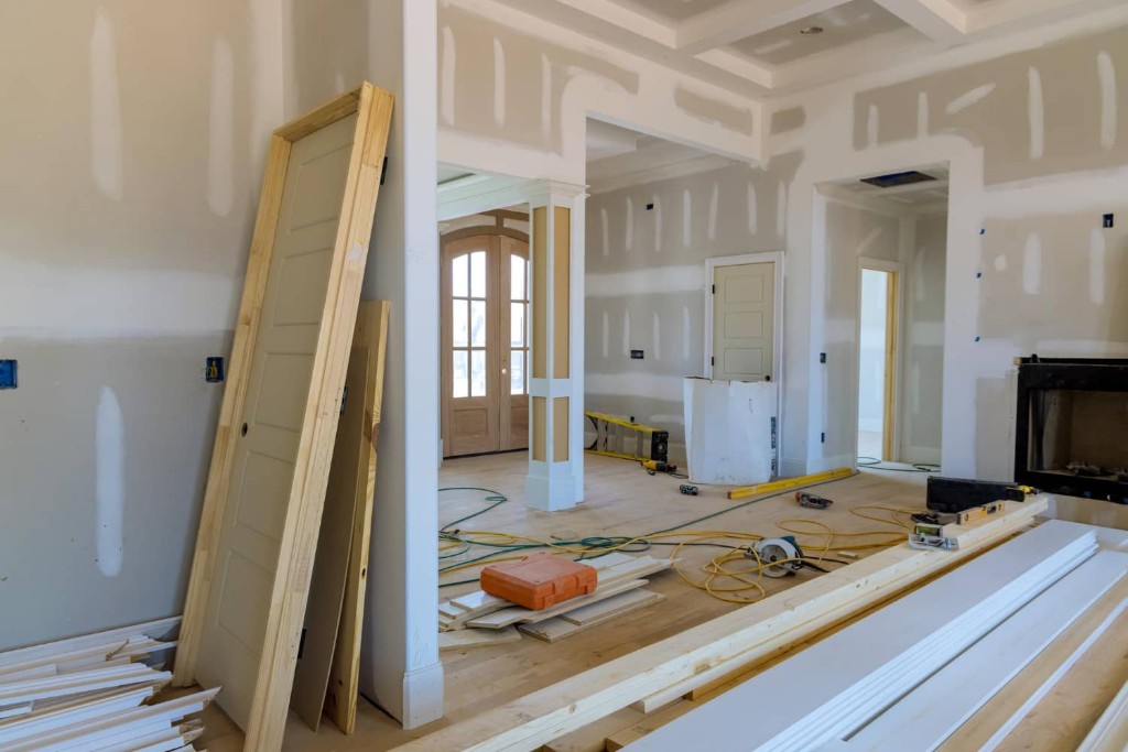 Residential interior remodel in progress with trim and doors staged on site
